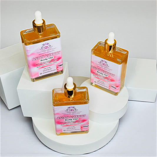 Three bottles of Asian Luxury Body Oil on a light background