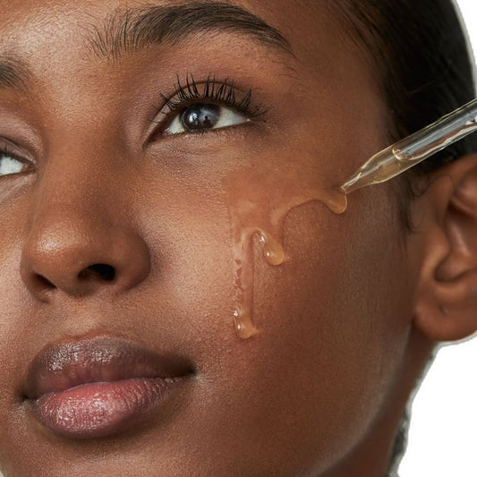 Woman receiving a professional Vitamin C treatment at an aesthetics clinic to brighten and rejuvenate her skin.